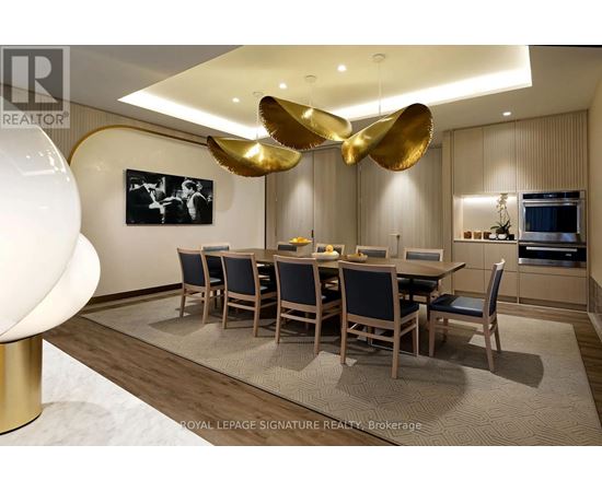 A dining room with a large table and chairs.
