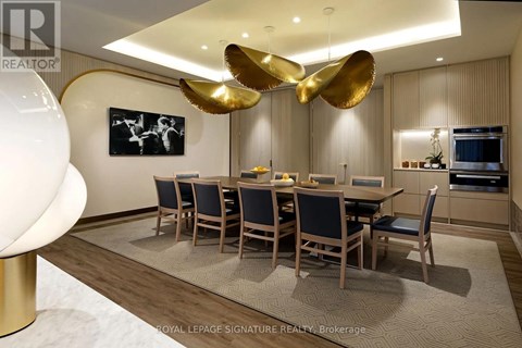 A dining room with a large table and chairs.