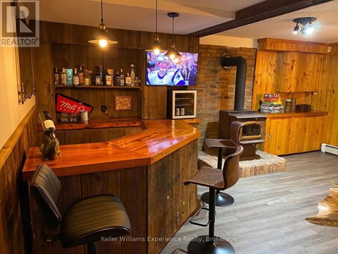 A bar with a wood grain counter top and a brick wall.