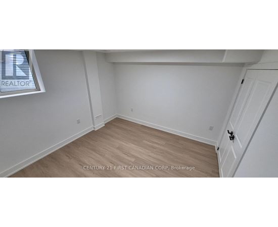 A room with a wooden floor and white walls.
