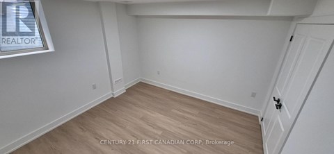 A room with a wooden floor and white walls.