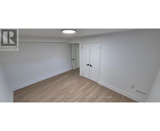 A white room with a wooden floor and a door.