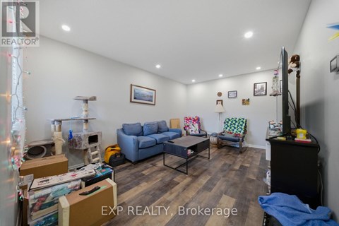 A living room with a couch, chair, and a table with boxes on it.