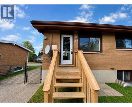 A house with a brown roof and a wooden staircase leading to the front door.