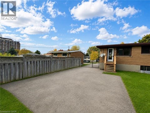 A realtor photo of a residential area with houses and a fence.
