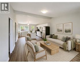 A well-lit living room with a couch, chairs, and a coffee table.