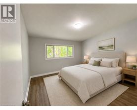 A bedroom with a large bed and a window.