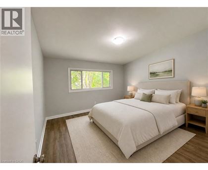 A bedroom with a large bed and a window.