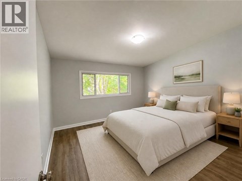 A bedroom with a large bed and a window.