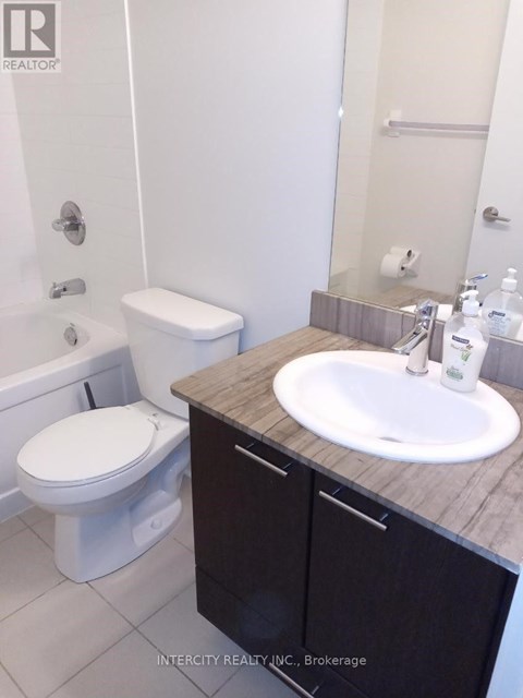 A white toilet sits next to a sink in a bathroom.