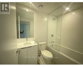 A bathroom with a toilet, sink, and shower.