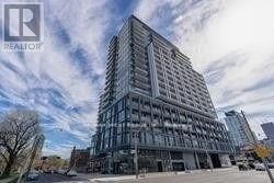 A tall building with many windows is under construction.