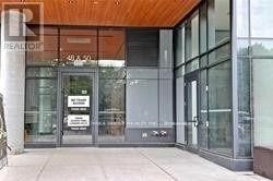 The image shows the front of a building with a glass door and a sign that reads "REALTOR".