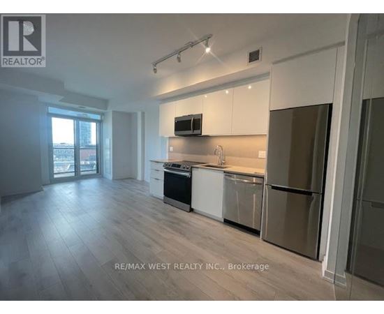 A spacious kitchen with white cabinets and stainless steel appliances.