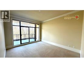 A room with a large window and a balcony is available for rent.