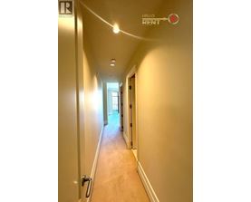 A long hallway with a sign that says "Hello Rent".