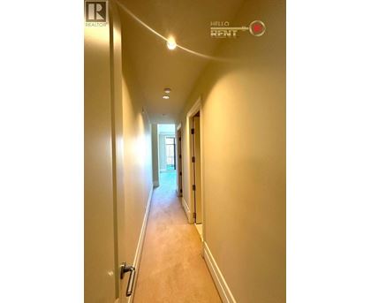 A long hallway with a sign that says "Hello Rent".