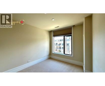 A room with a window showing a view of a building outside.