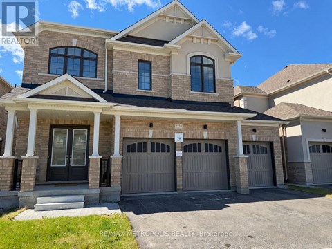 A large, two-story house with a garage is for sale.