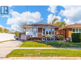 A house with a lawn in front of it is for sale.