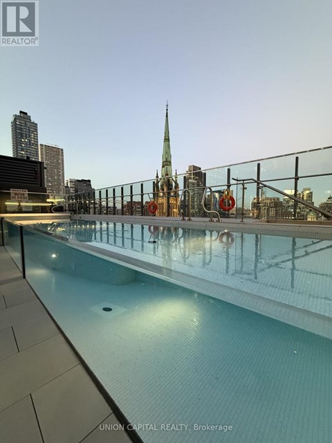 A pool with a cityscape in the background.