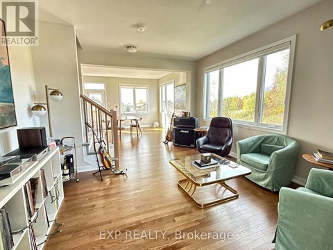 A living room with a green chair and a coffee table.
