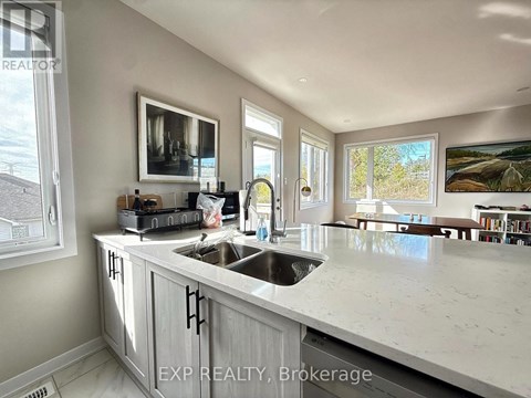 A kitchen with a sink and a window.