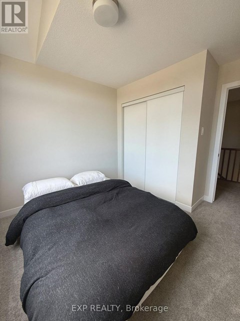 A bedroom with a bed and a white door.