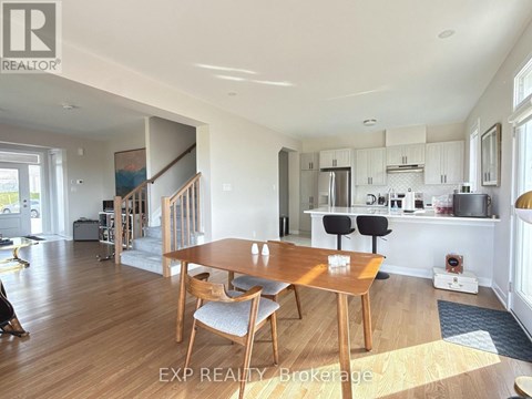 A dining room with a wooden table and chairs.