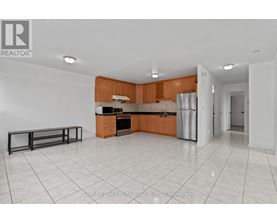 A kitchen with white tiled floors and wooden cabinets.