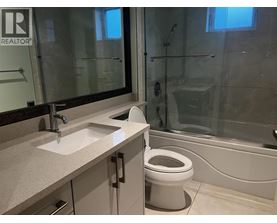 A bathroom with a toilet, sink, and bathtub.