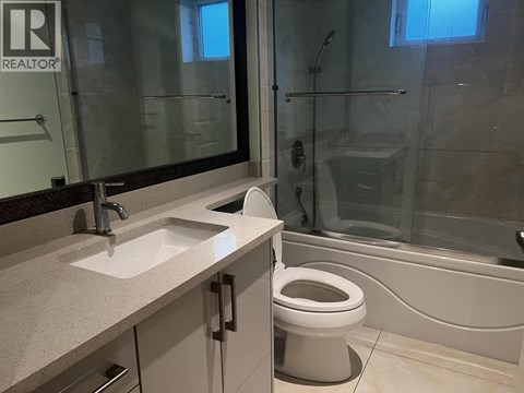 A bathroom with a toilet, sink, and bathtub.