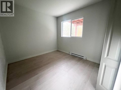 A room with a window and a door.