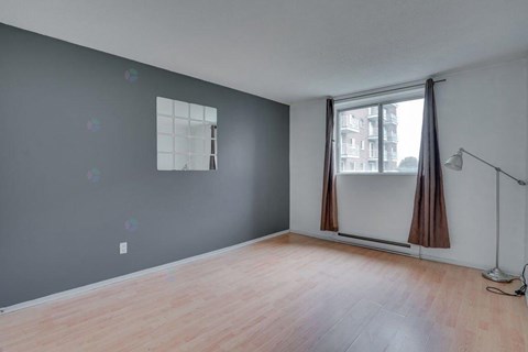 A room with a window and a lamp.