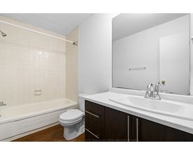 A white bathroom with a toilet, sink, and bathtub.