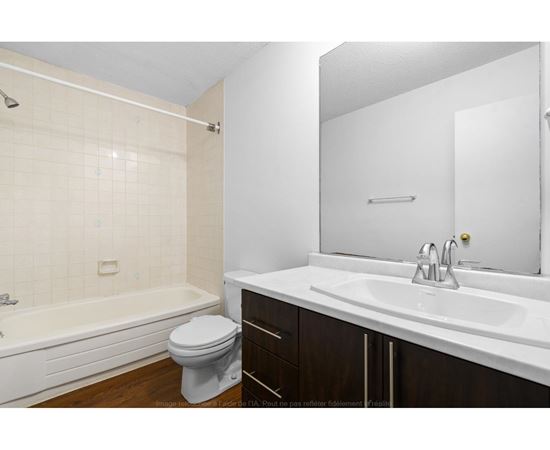 A white bathroom with a toilet, sink, and bathtub.