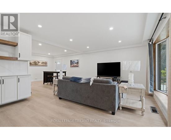 A modern living room with a grey couch and a flat screen TV.