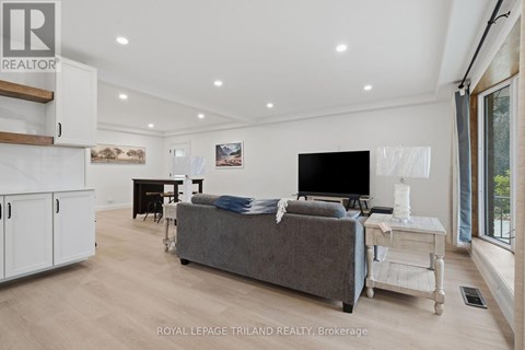 A modern living room with a grey couch and a flat screen TV.