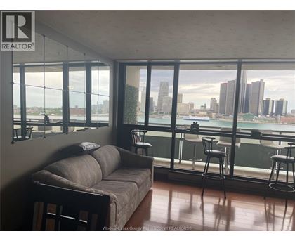 A living room with a couch and a view of the city.