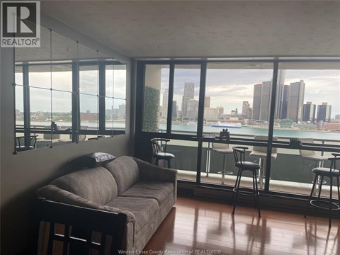 A living room with a couch and a view of the city.