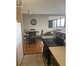 A kitchen with a table and chairs.
