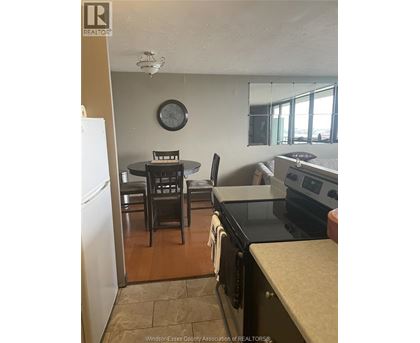 A kitchen with a table and chairs.