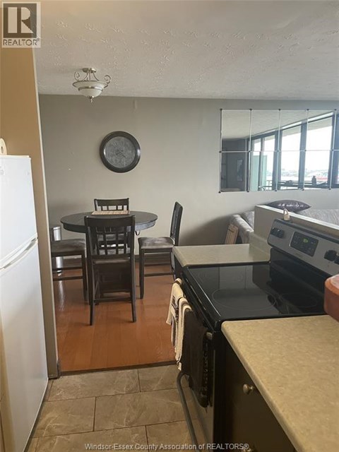A kitchen with a table and chairs.