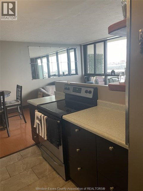 A kitchen with a black oven and a white counter top.