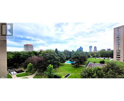 A view of a city from a high vantage point with a pool in the foreground.