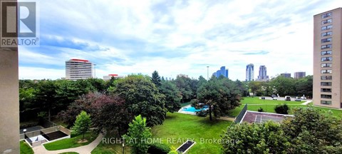 A view of a city from a high vantage point with a pool in the foreground.