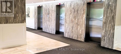 A hallway with a sign that says "REALTOR" on the wall.