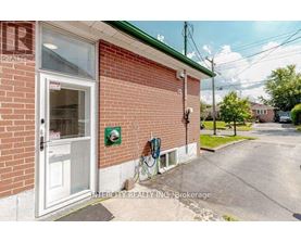 A brick building with a white door and a sign that says Intercity Realty Inc. Brokerage.
