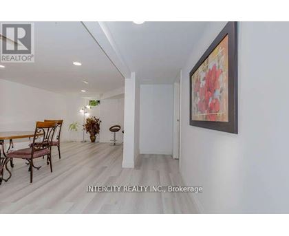 A room with a dining table and chairs in it.