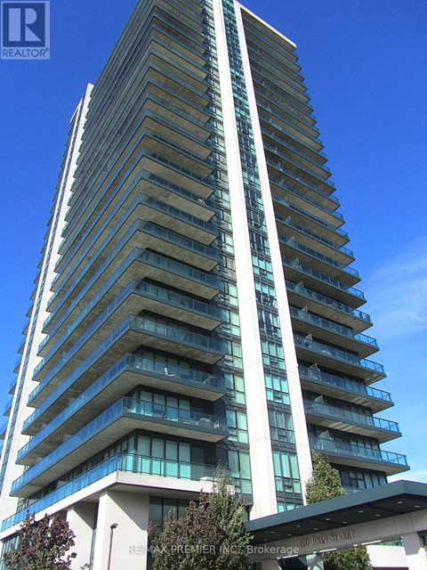 A tall residential building with balconies on each floor.